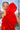 Vestido invitada rojo con falda capa y abertura